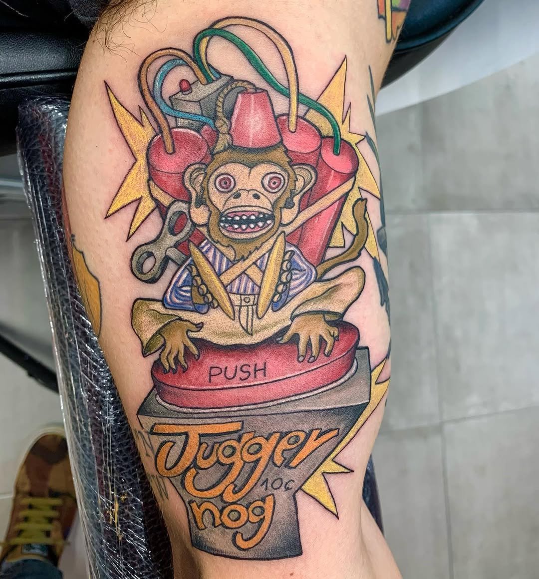 Tatuaje profesional en estudio MartinK Tattoo del mono con platillos y una bomba